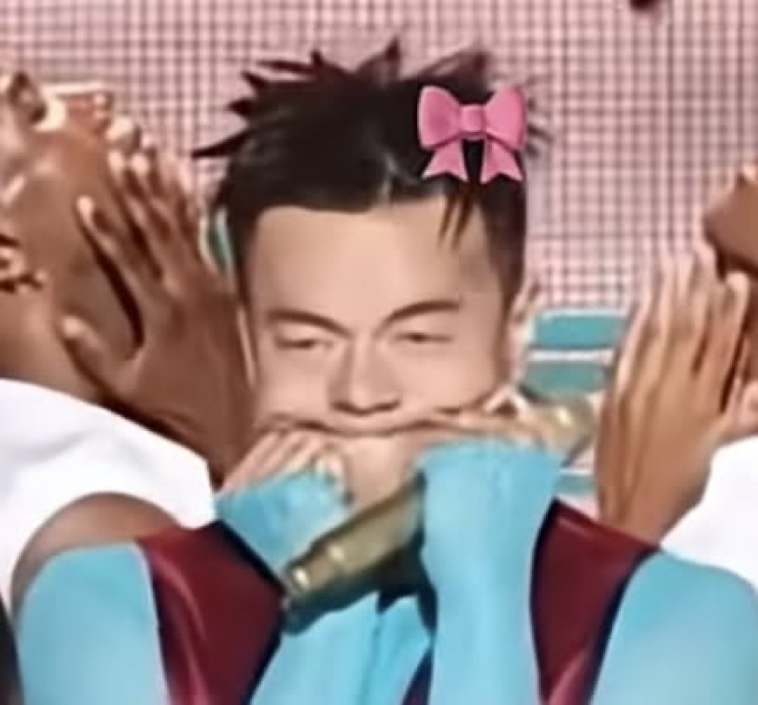 K-pop performer onstage with a pink bow, face mashed between hands holding a mic, eyes scrunched shut