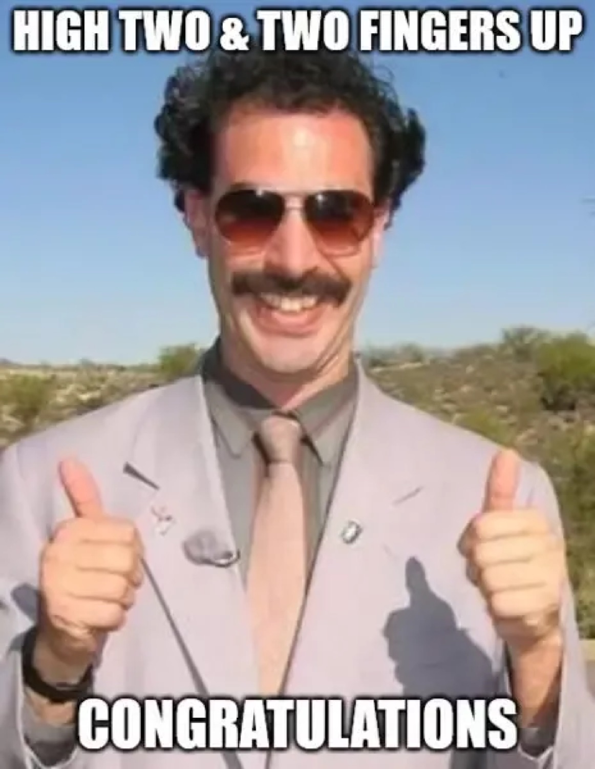 Borat giving two thumbs up: 'HIGH TWO & TWO FINGERS UP / CONGRATULATIONS'