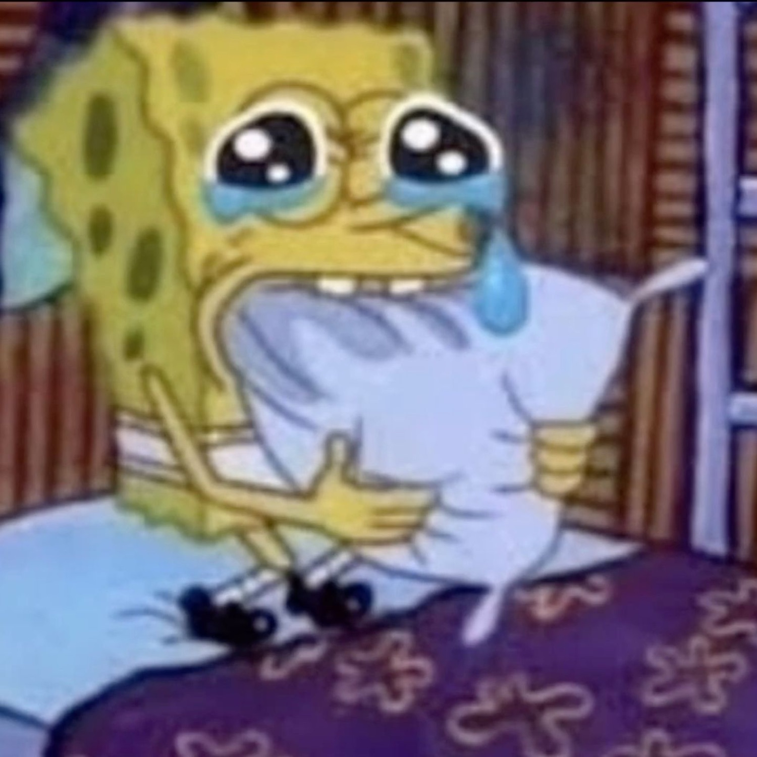 SpongeBob sobbing in bed while clutching a pillow, tears streaming down