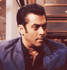 Salman Khan in a blue jacket giving a sly smirk
