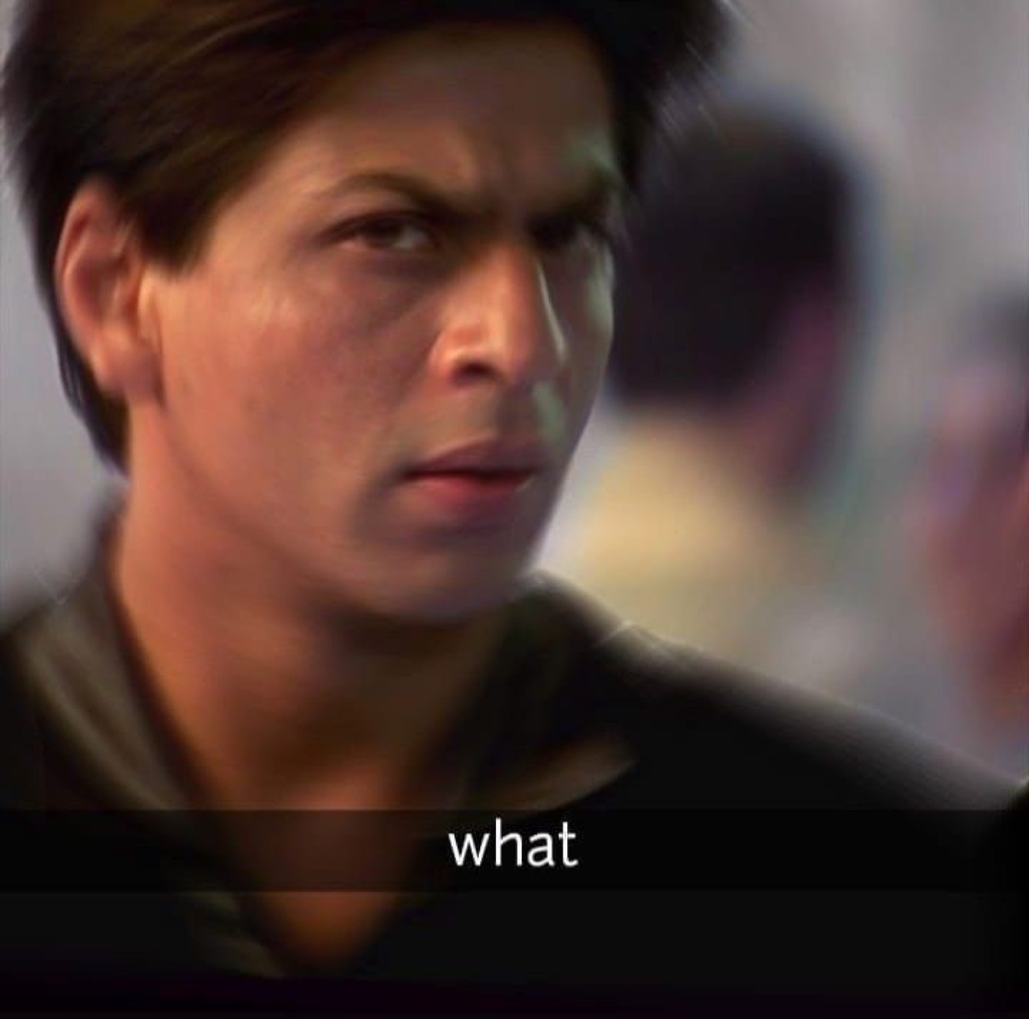 Shah Rukh Khan turning with an intense confused glare, subtitle 'what'