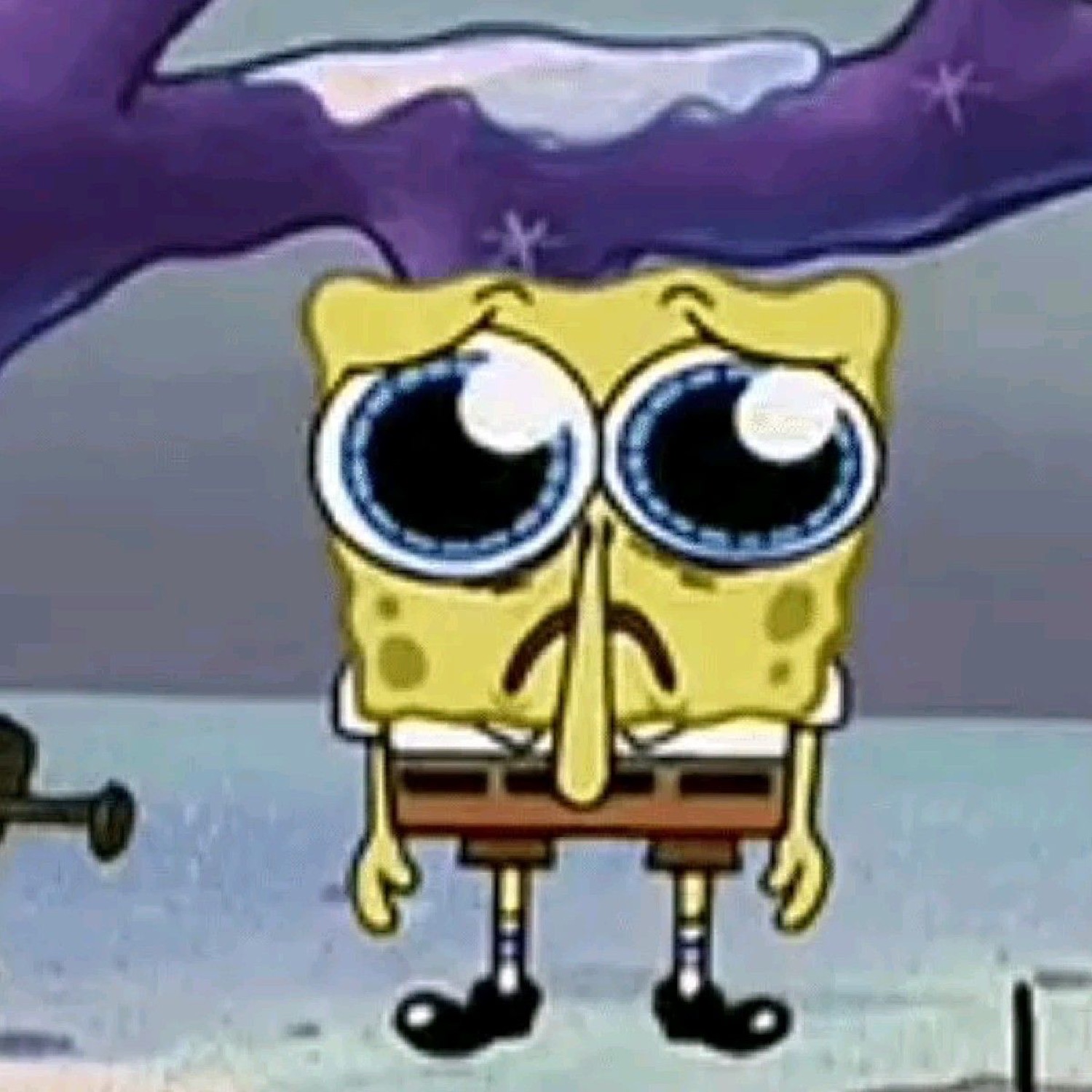 SpongeBob SquarePants standing alone looking deeply sad with watery puppy eyes