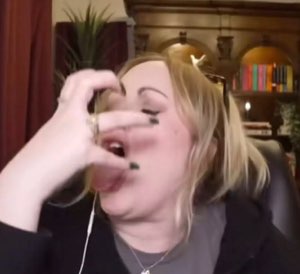 Woman pressing her hand over her face in a full facepalm moment on a video call