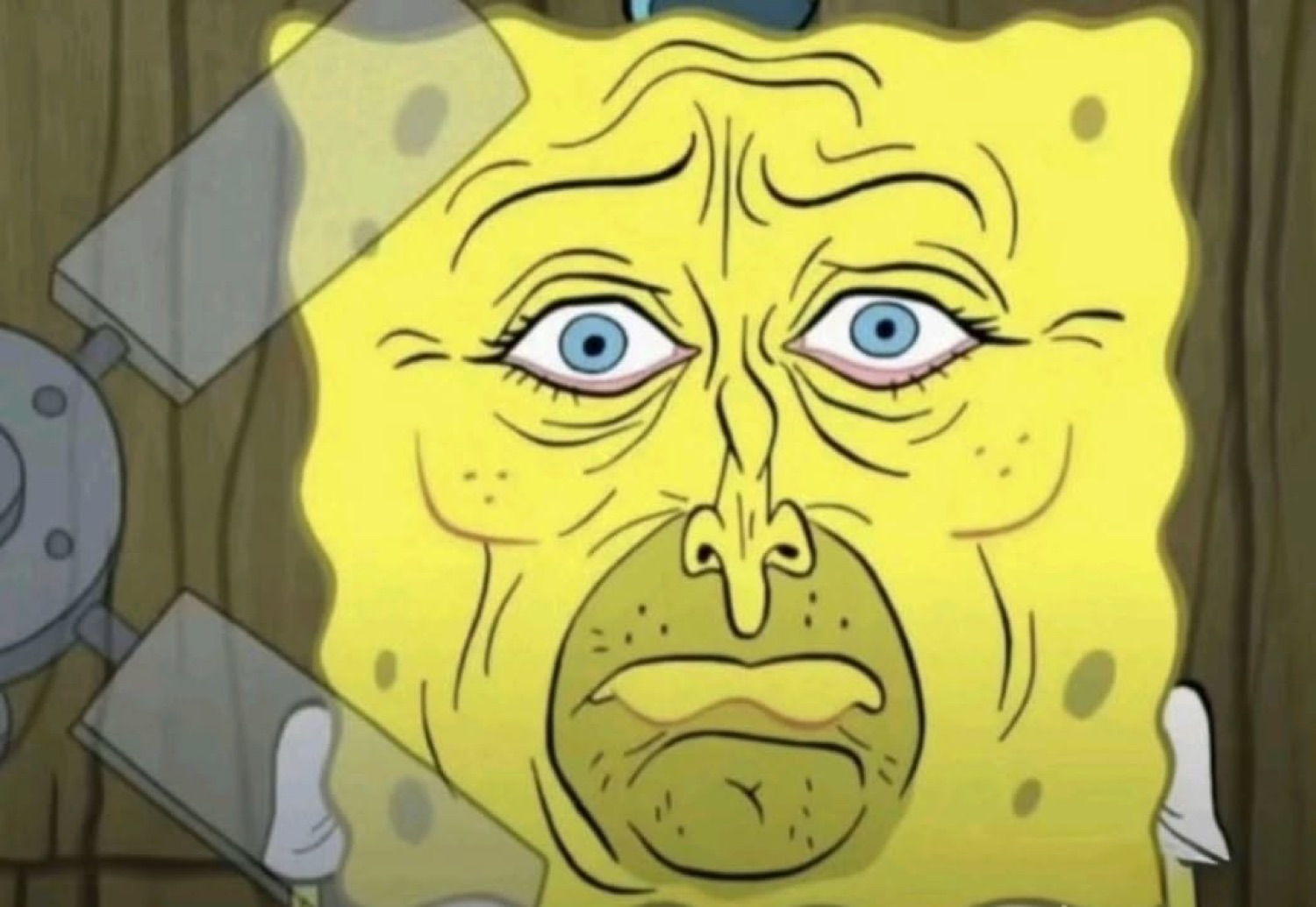 Wrinkled, saggy-faced SpongeBob staring ahead looking absolutely worn out