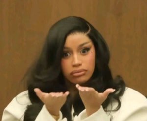 Cardi B with palms up in a 'what did you expect' shrug