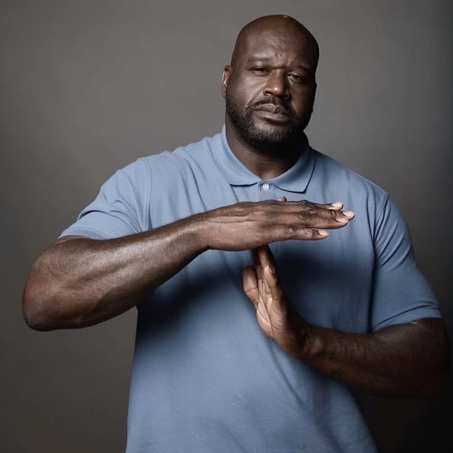 Shaquille O'Neal making a deadpan 'time out' gesture with his hands