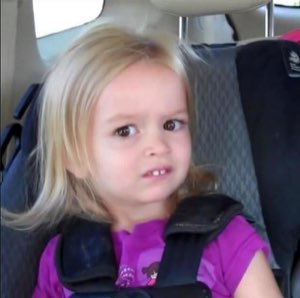 Little girl in a car seat side-eyeing with a deeply skeptical, let-down face