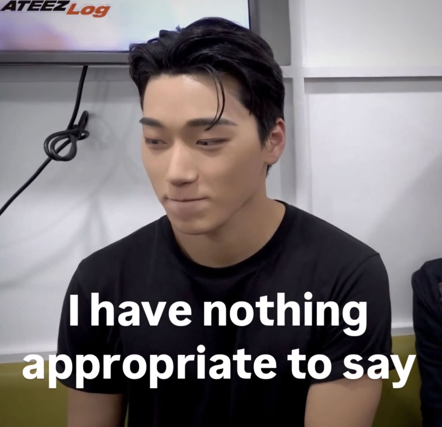 ATEEZ member looking down expressionlessly with 'I have nothing appropriate to say'