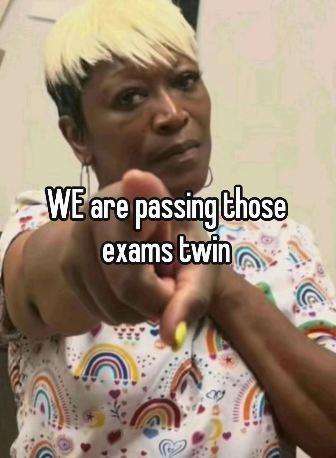 Woman pointing at the camera: 'WE are passing those exams twin'