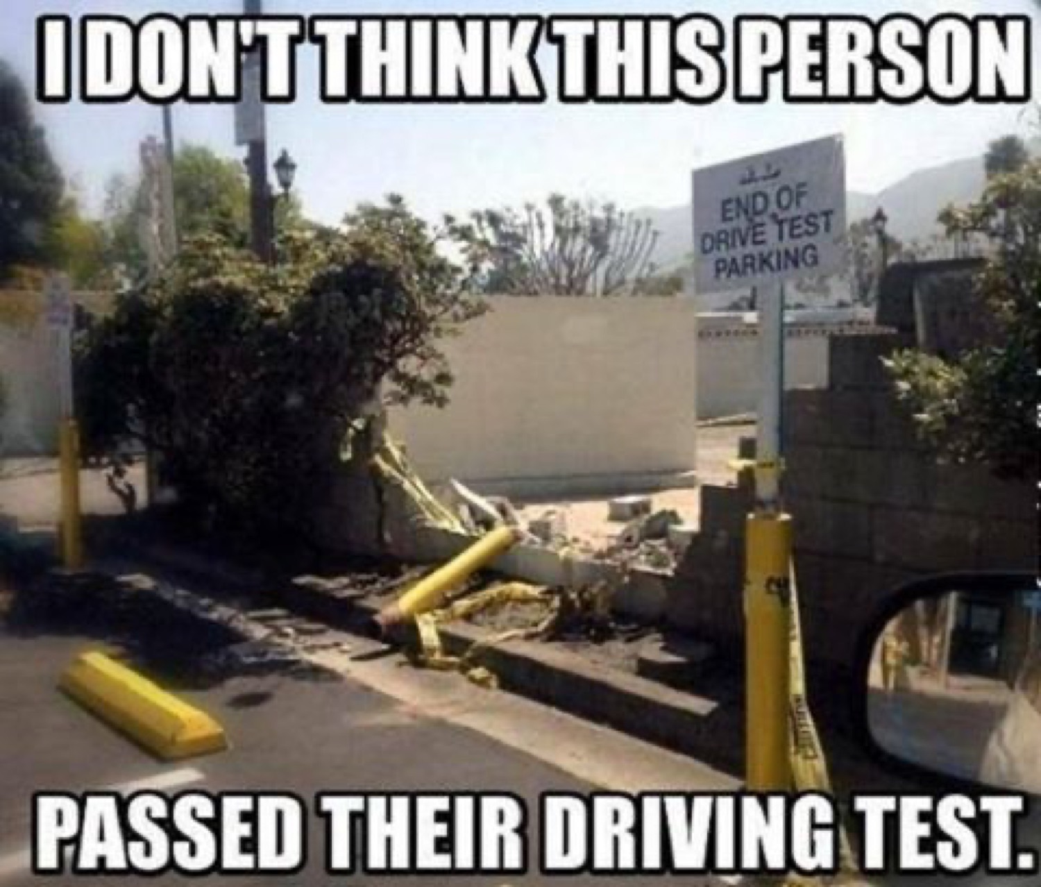 Car crashed into a wall by the test lot: 'I DON'T THINK THIS PERSON PASSED THEIR DRIVING TEST'