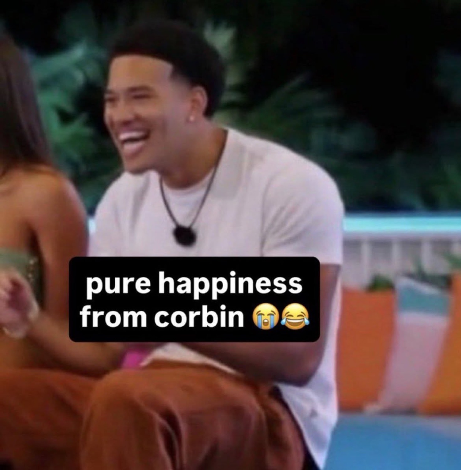 Love Island USA's Corbin laughing on a couch under 'pure happiness from corbin ๐ญ๐'