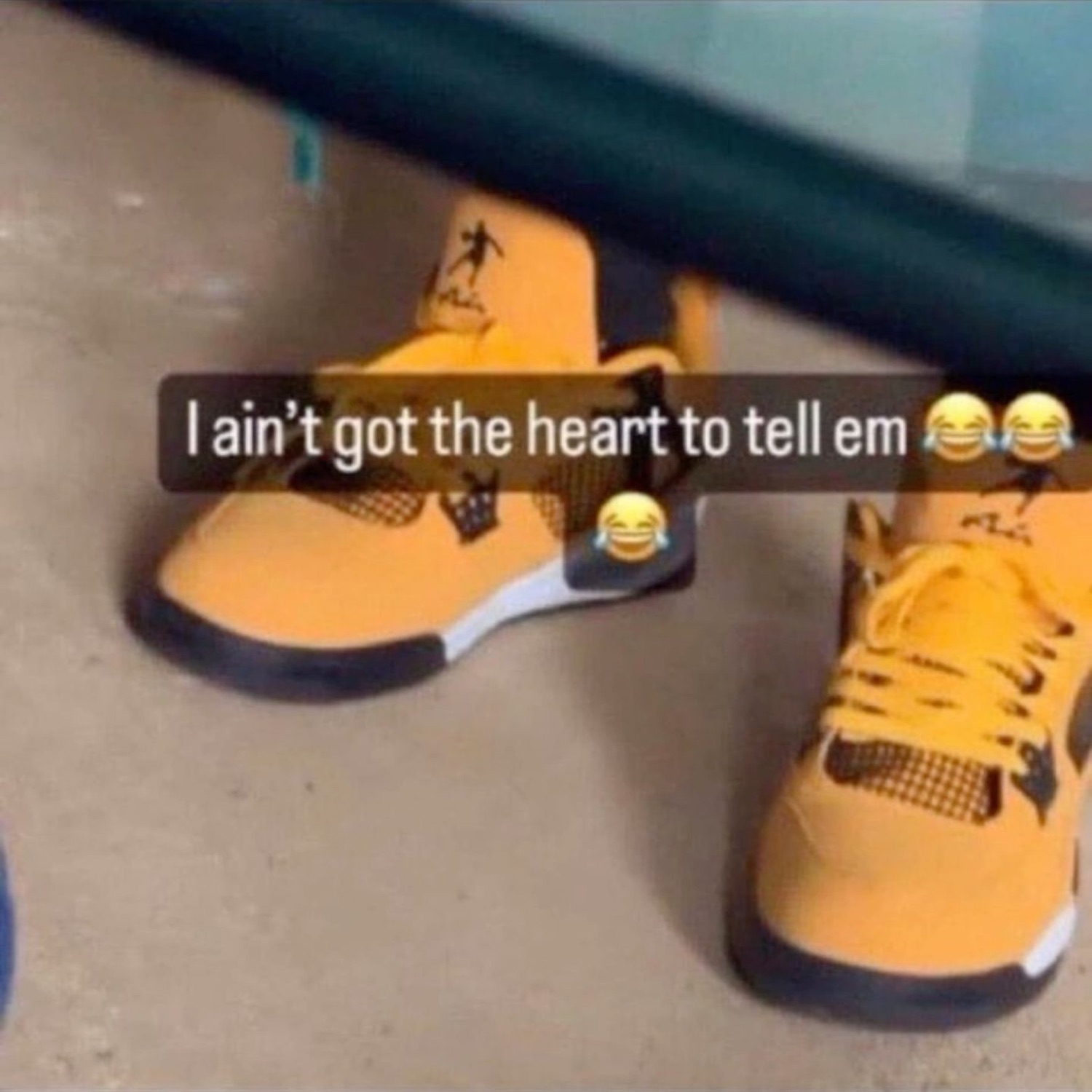Feet in yellow bootleg Jordans with a weird logo under 'I ain't got the heart to tell em 😂😂😂'