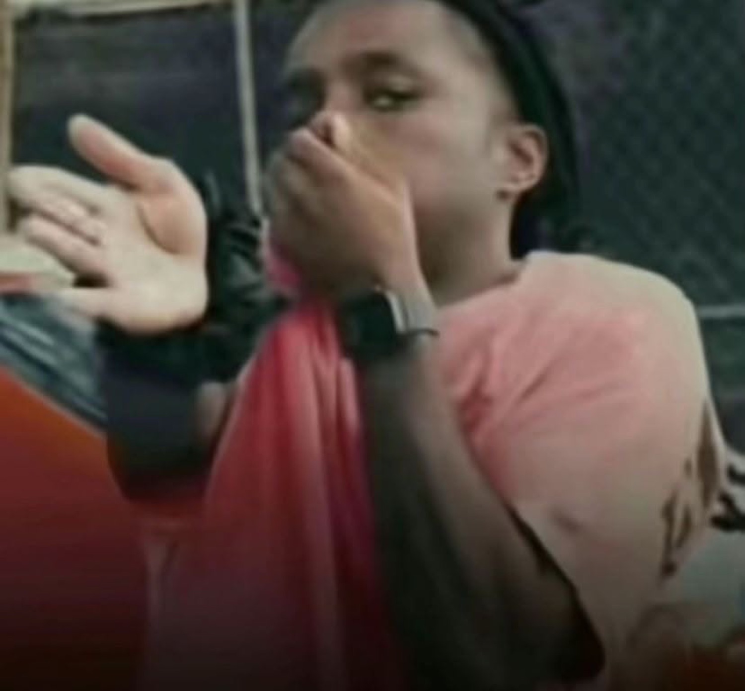 Guy covering his mouth in shock and holding a hand up