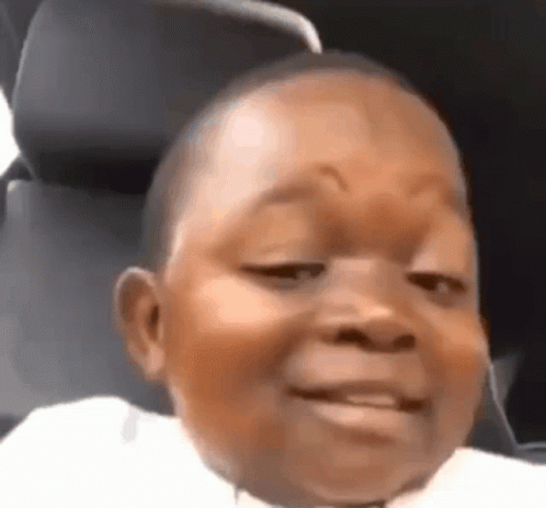 Kid in a car seat throwing the most skeptical little side-eye