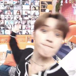 Blurry motion shot of a K-pop trainee pulling a goofy face at the camera
