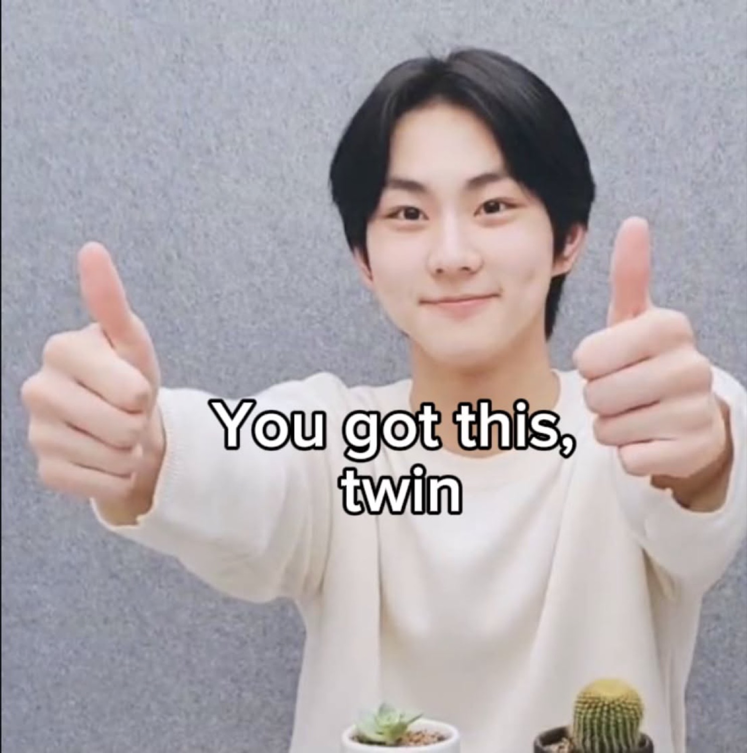 Young man giving two thumbs up with a confident smile captioned 'You got this, twin'