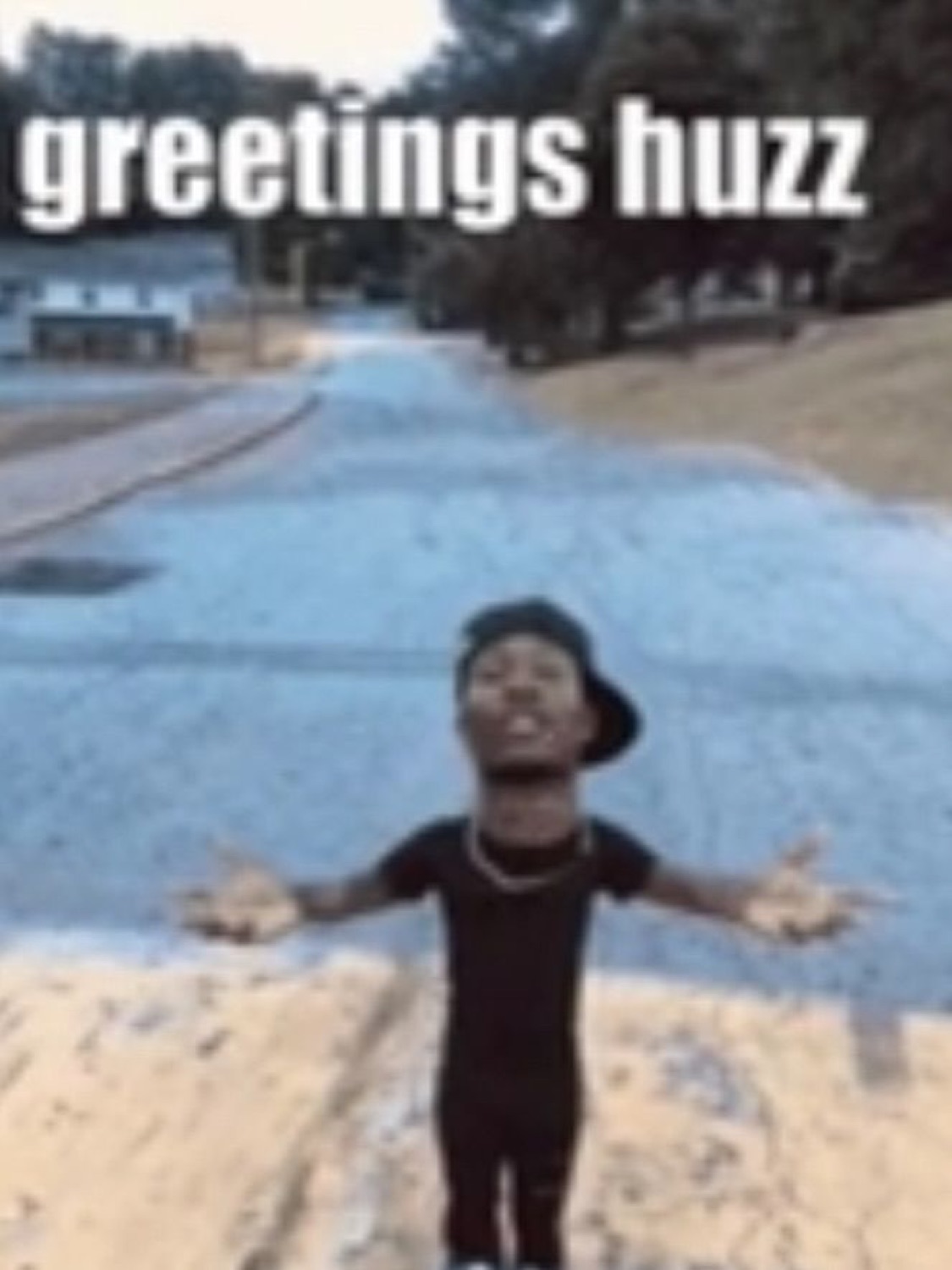 Man with arms spread wide and a big grin captioned 'greetings huzz'