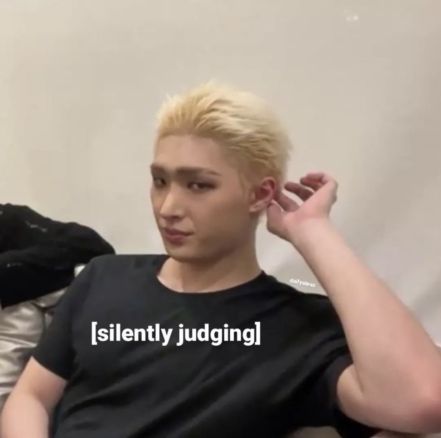 Bleach-blond guy lounging with a smirk, captioned '[silently judging]'