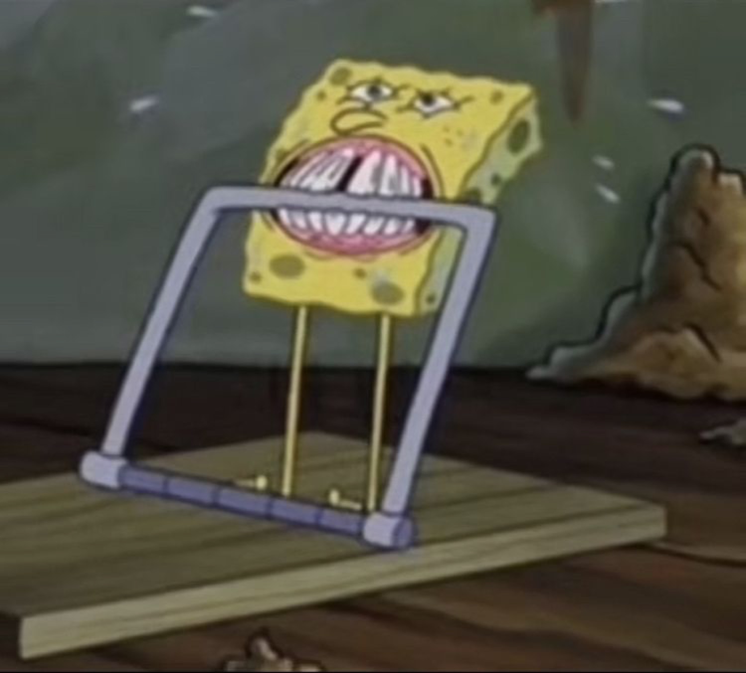 SpongeBob's face stretched grotesquely showing huge teeth in a cage frame, pure rage