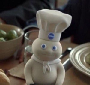 Pillsbury Doughboy figurine looking up with a blank, slightly uncomfortable expression