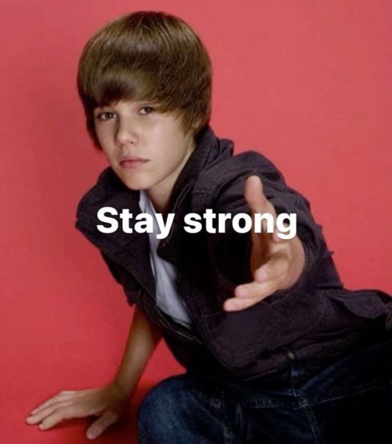 Young Justin Bieber reaching toward camera captioned 'Stay strong'