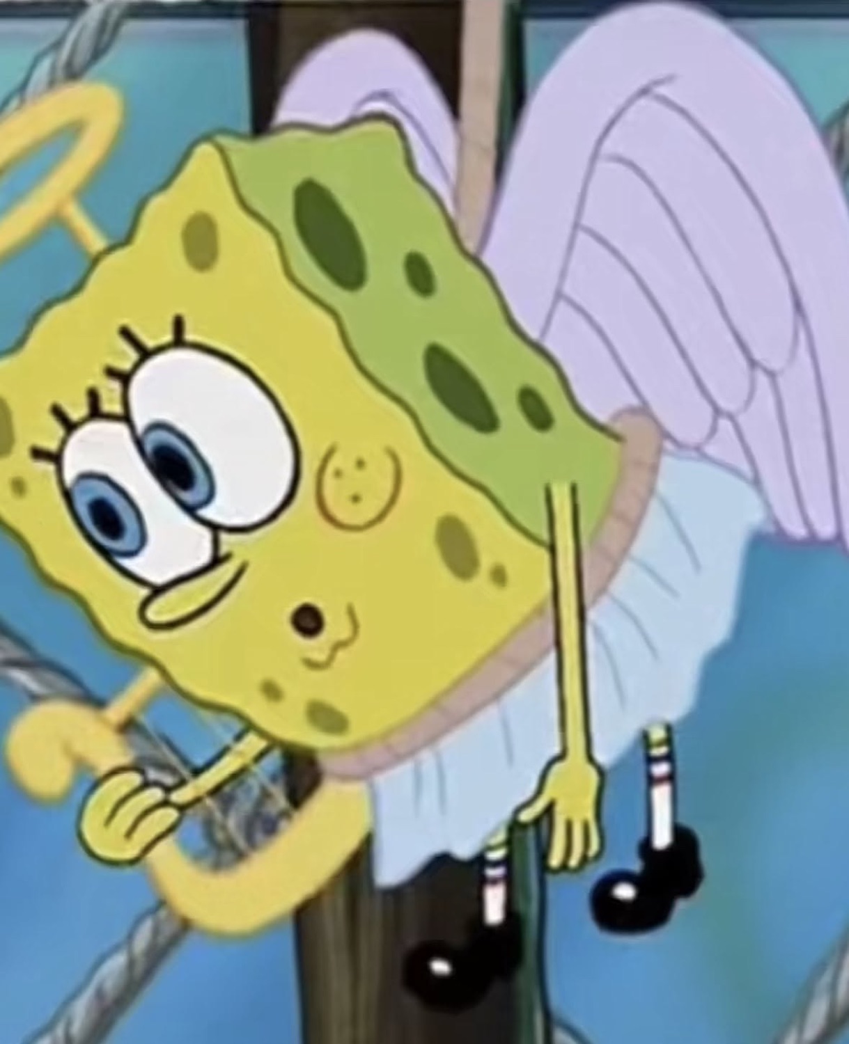 SpongeBob dressed as an angel with halo and wings, giving an uneasy forced smile