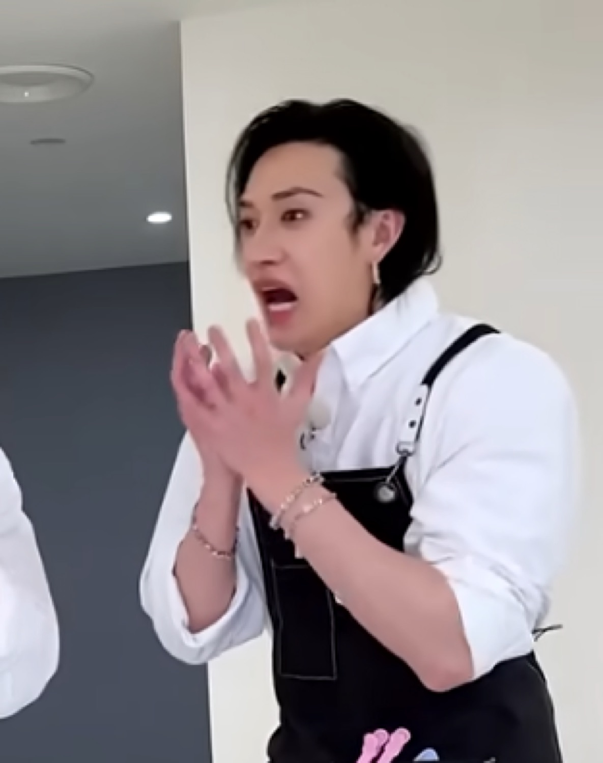 Guy in overalls clasping his hands, mouth open in total disbelief