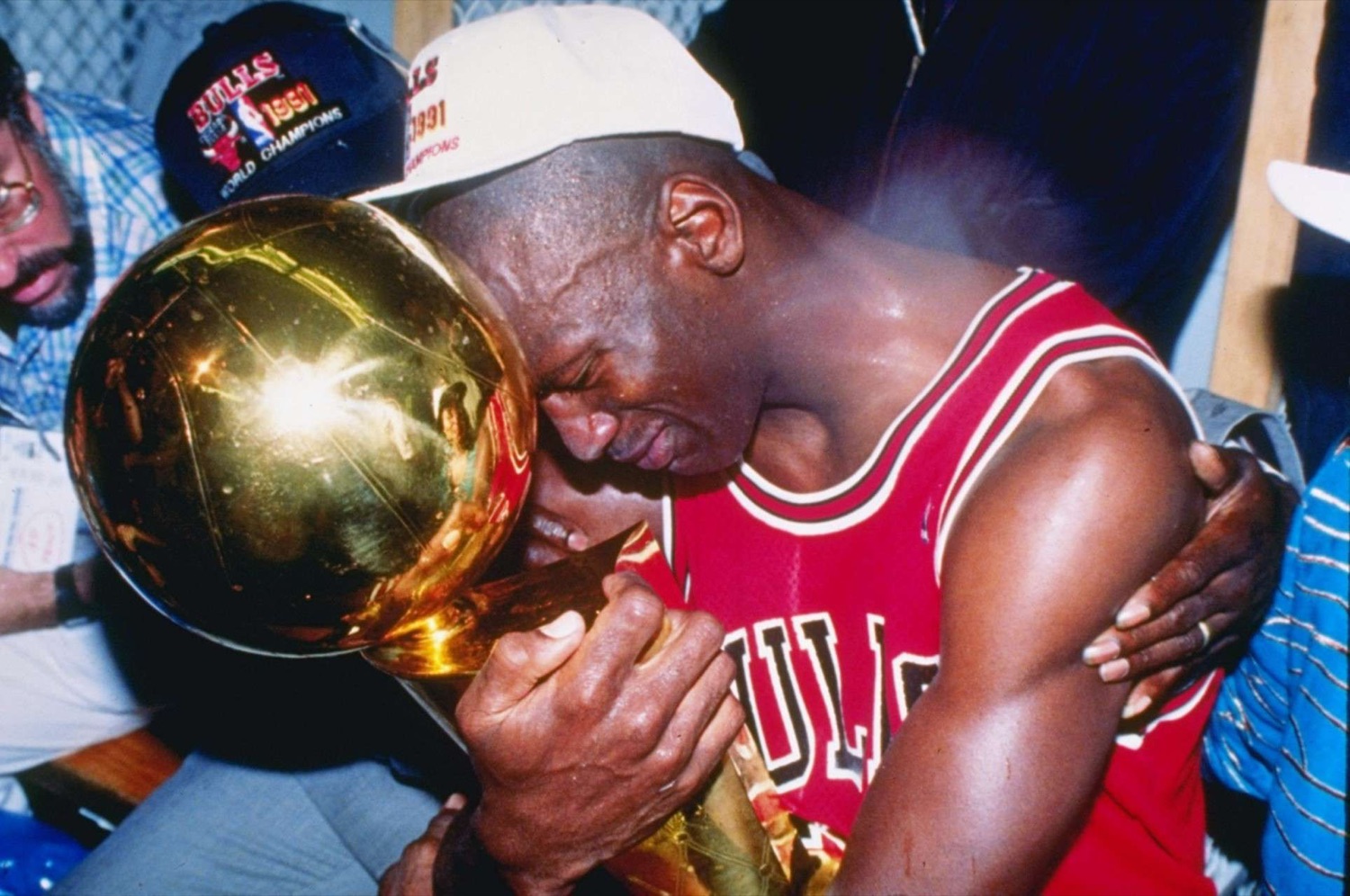 Michael Jordan crying while hugging the championship trophy