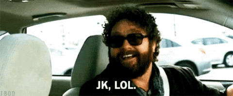 Zach Galifianakis in a car in sunglasses, "JK, LOL."