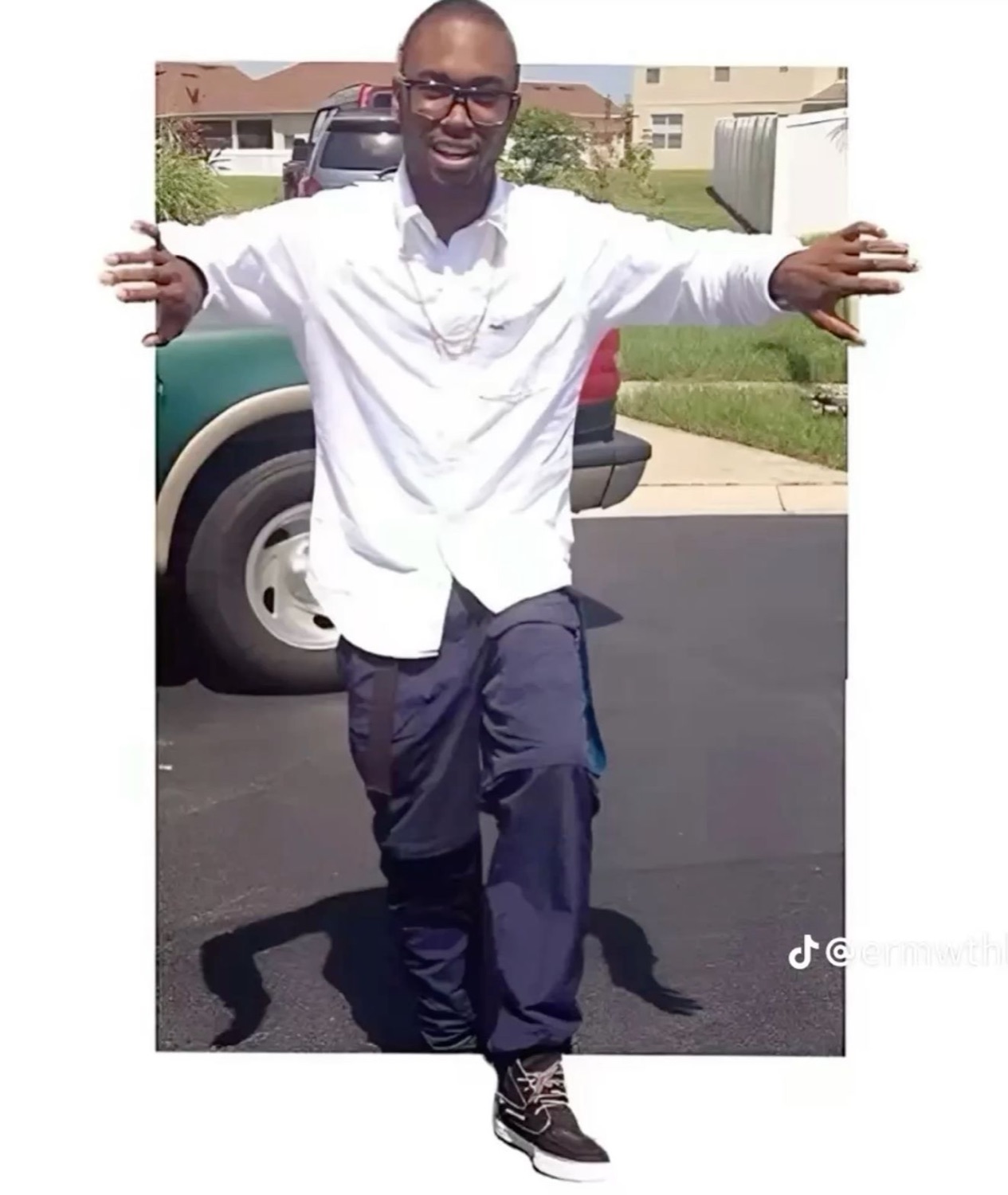 Man stepping out of a car door with his arms wide