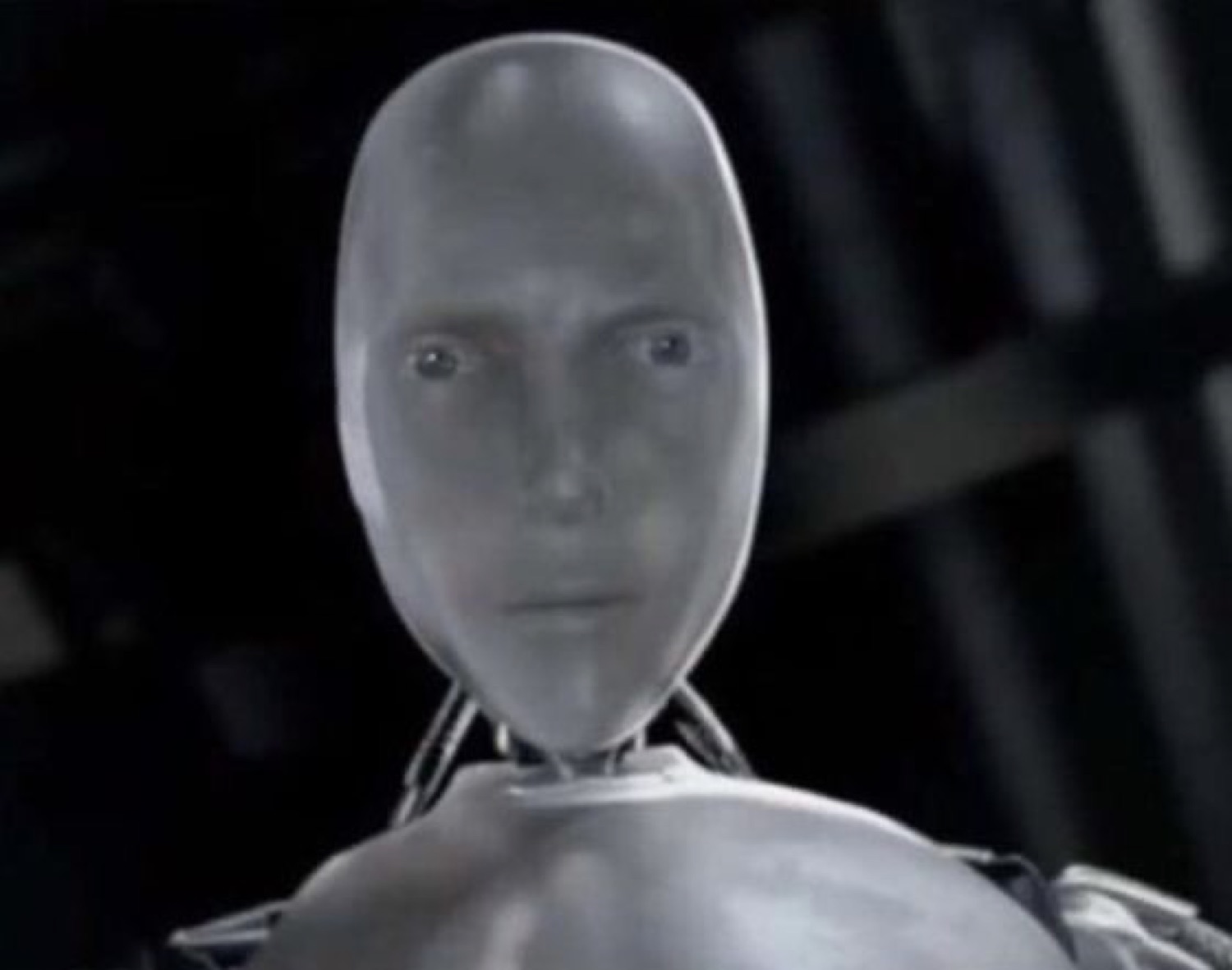 Silver humanoid robot staring straight ahead with a blank, emotionless expression