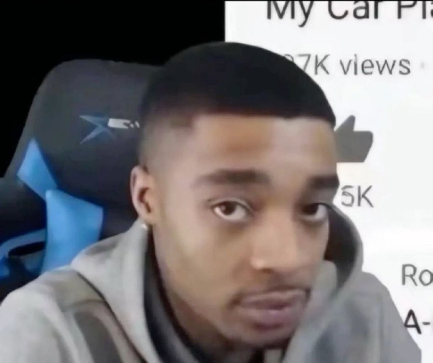 A man in a gaming chair giving a flat, unimpressed stare at the camera