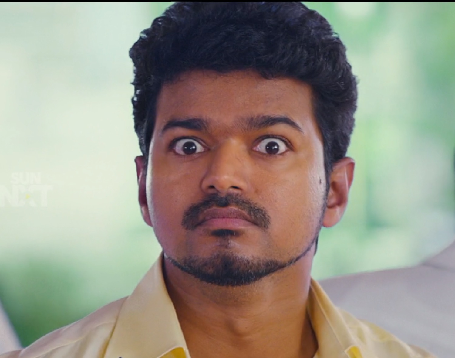 Vijay staring with wide shocked eyes