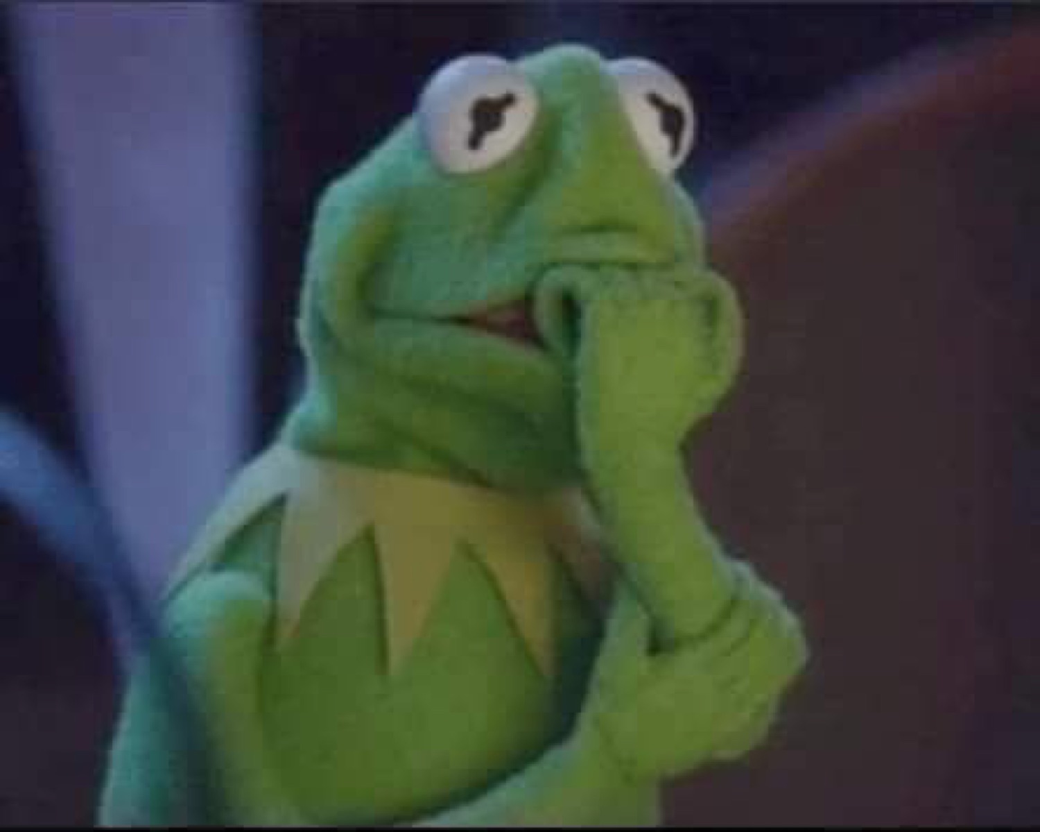 Kermit the Frog with a hand to his mouth looking anxious and worried