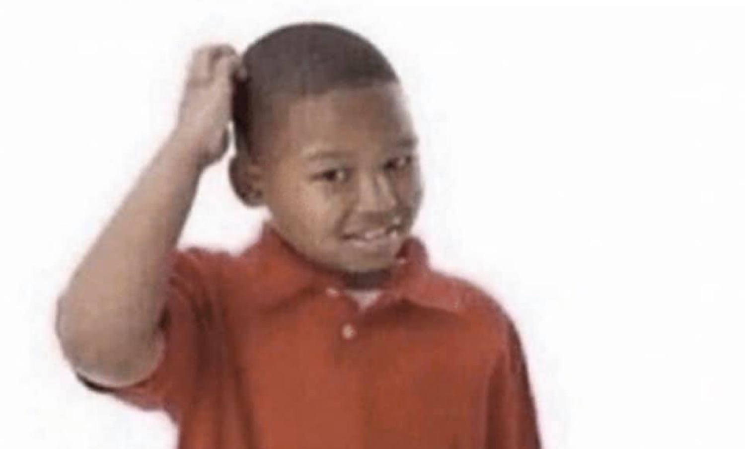 Kid in a red polo scratching his head with a sheepish, awkward grin