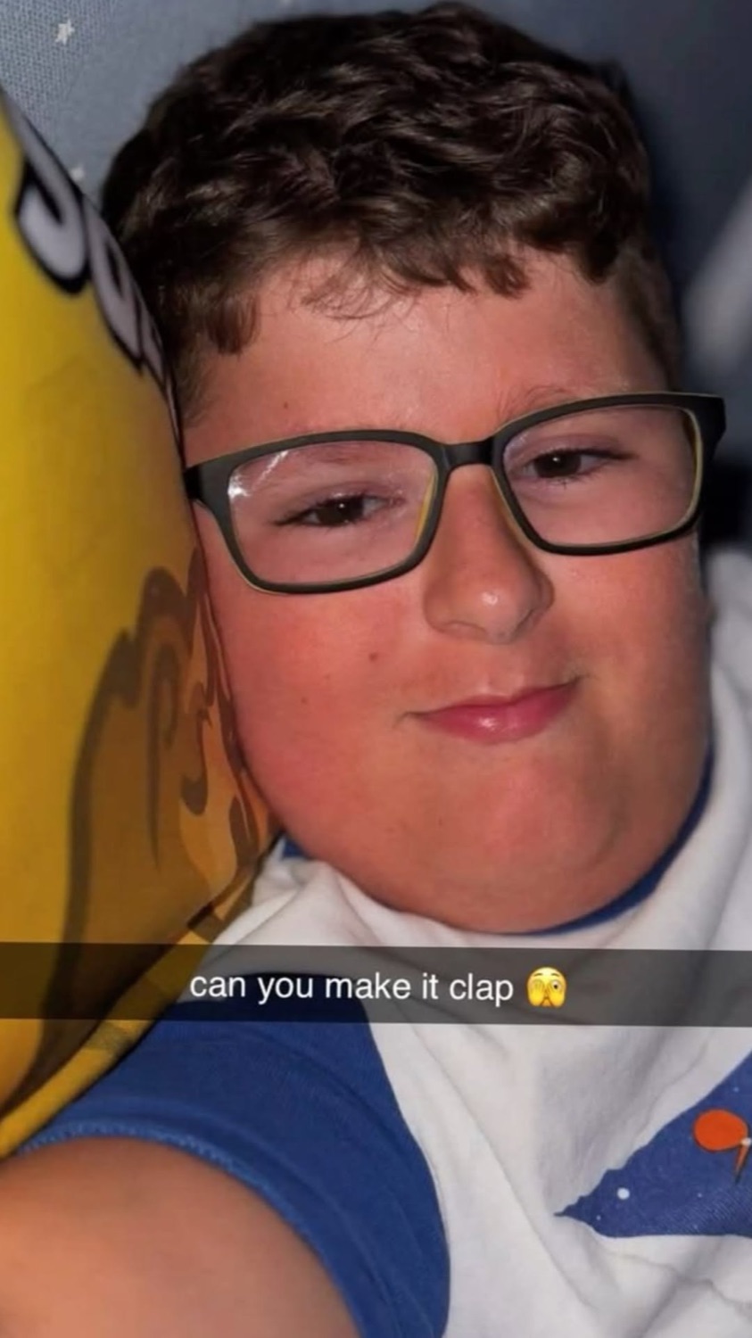 Kid in glasses giving a smug half-smirk over the caption 'can you make it clap'