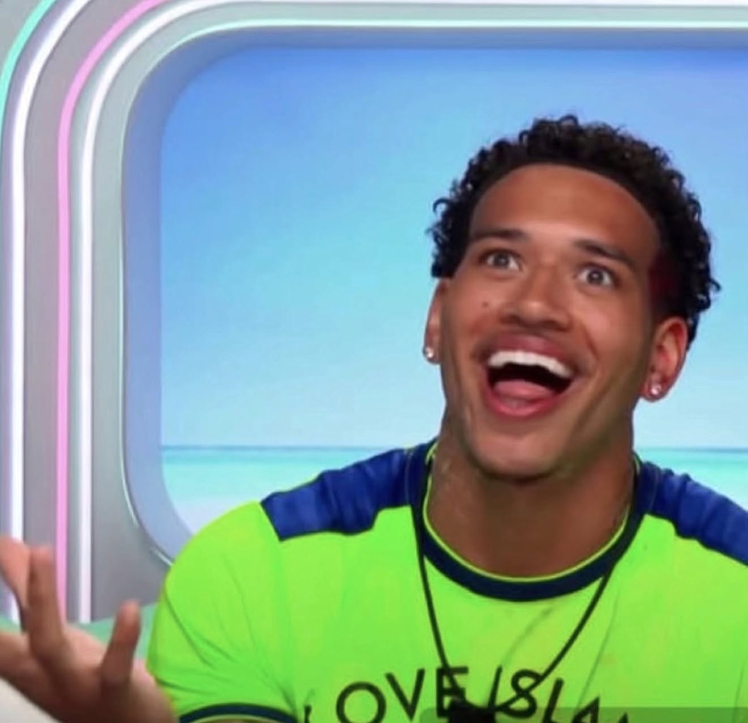 Love Island USA's Corbin laughing with his head back and a hand out, mid-explanation
