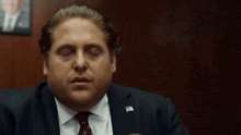 Jonah Hill rubbing his eyes in exhaustion
