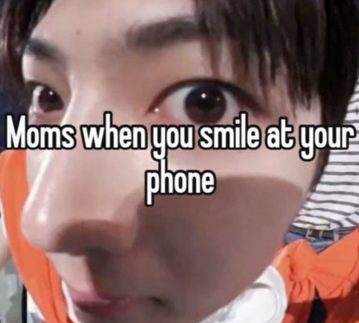 Extreme close-up of wide staring eyes captioned 'Moms when you smile at your phone'