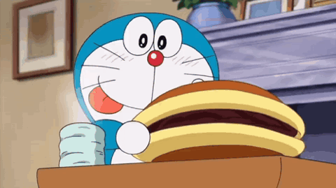 Doraemon happily stuffing a dorayaki pancake into his mouth