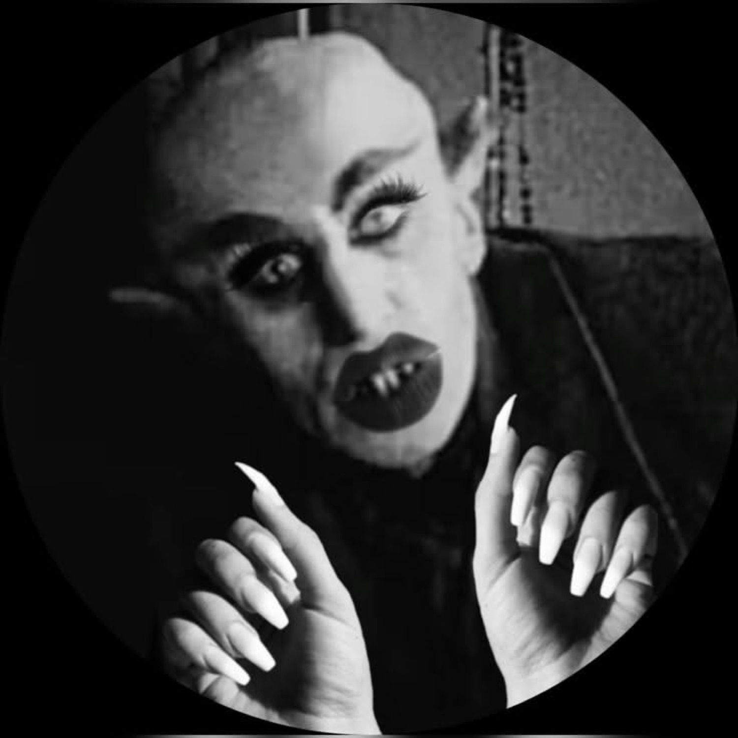 Nosferatu with long claw-like fingers raised menacingly