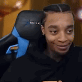 FlightReacts in a gaming chair laughing with his tongue hanging out, the freaky tongue face