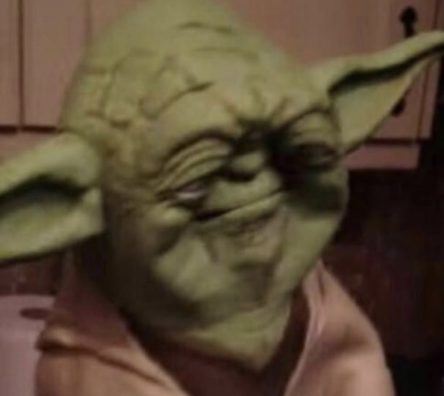 Yoda squinting with a sly grin