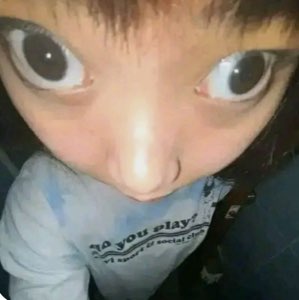Distorted wide-eyed close-up of a person warped into a cursed face