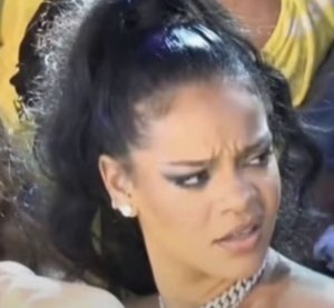 Woman in a crowd scrunching her face in confused disgust