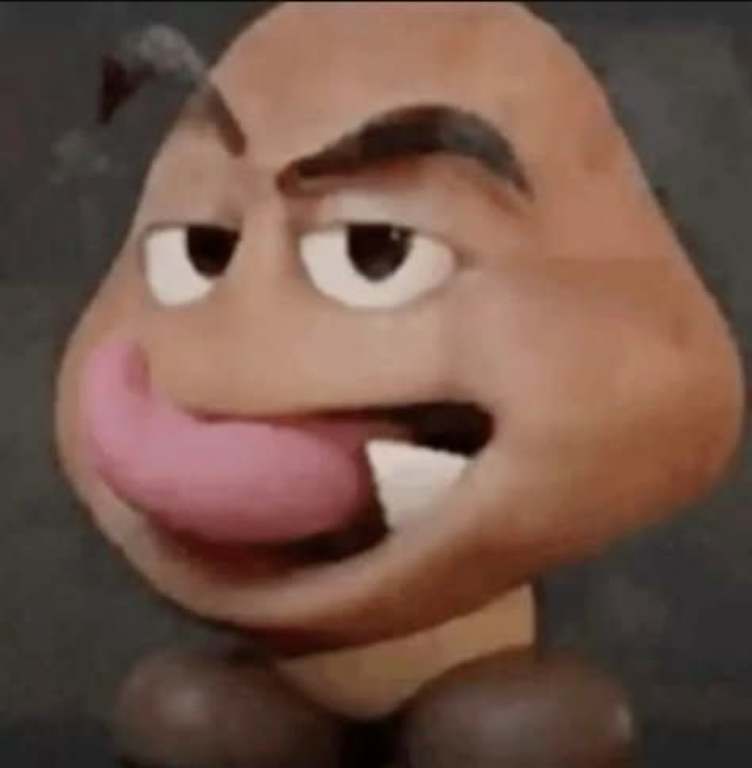 Cursed Goomba face with a raised eyebrow and tongue lolling out in a smug taunt