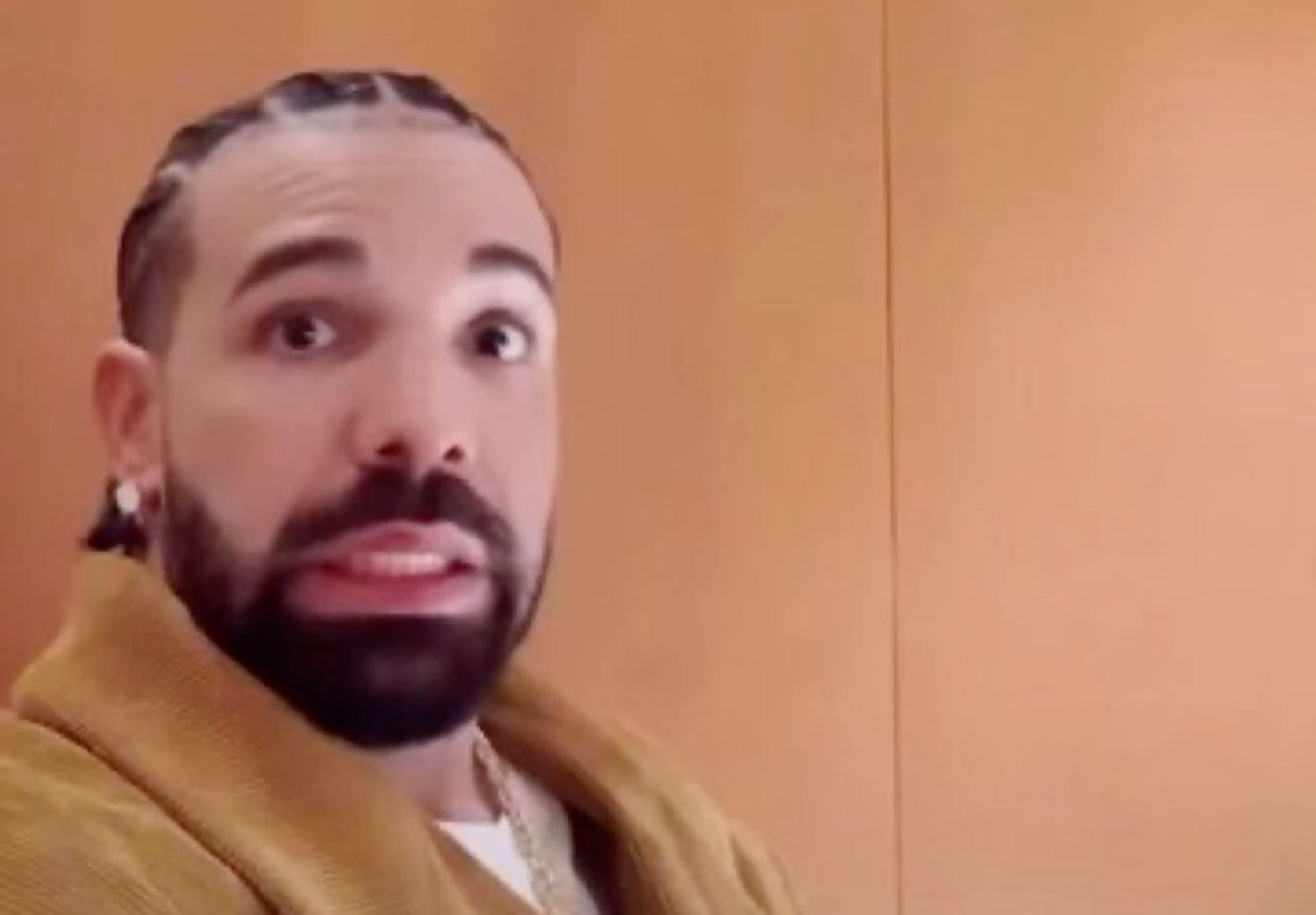 Drake bug-eyed and open-mouthed looking genuinely caught off guard