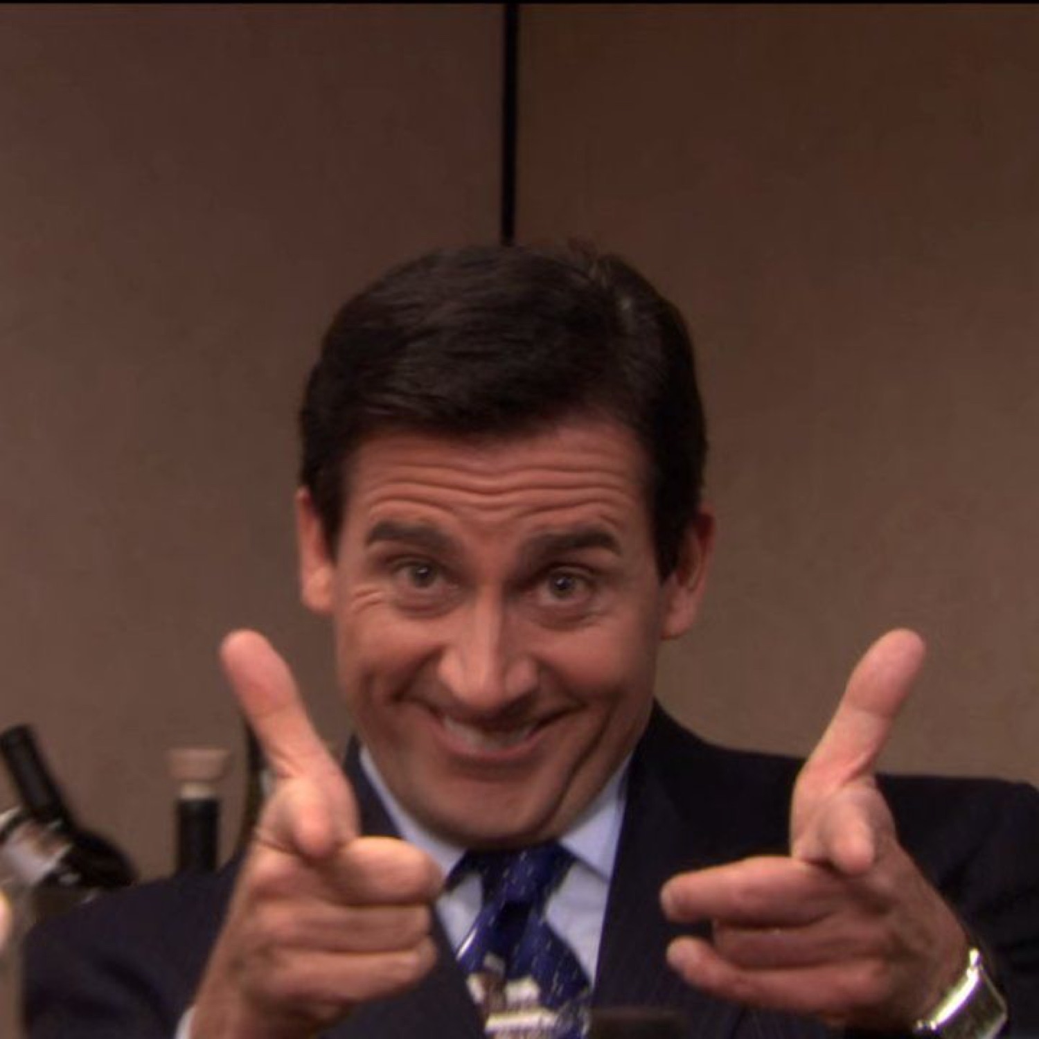 Michael Scott pointing double finger guns with a huge grin