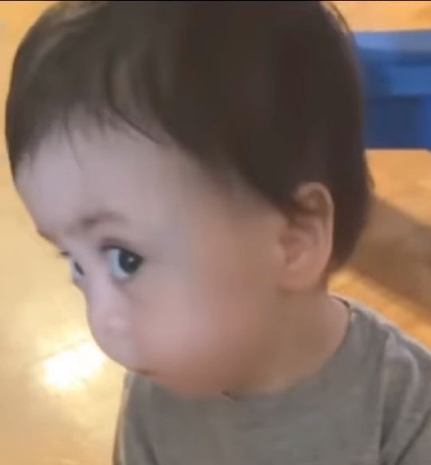 Toddler staring blankly off to the side with a totally unbothered face