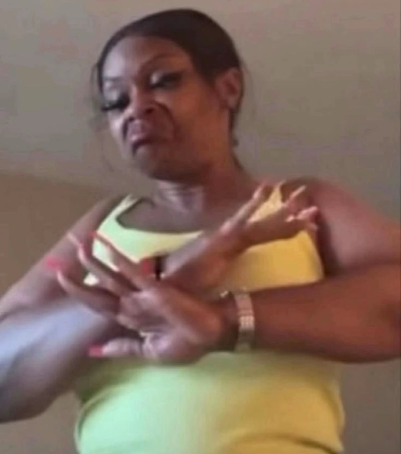 Woman with half-closed eyes gesturing with her hands in a slow, unbothered way